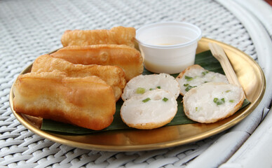 Fried patongko and Kanom krok or coconut-rice pancake on golden plate. - obrazy, fototapety, plakaty