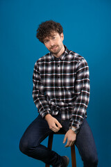 Obraz premium handsome man with handsome dreamy look posing at camera on blue background