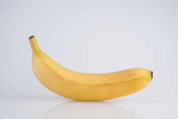 Whole yellow banana with peel isolated on white background with copy space, clipping path
