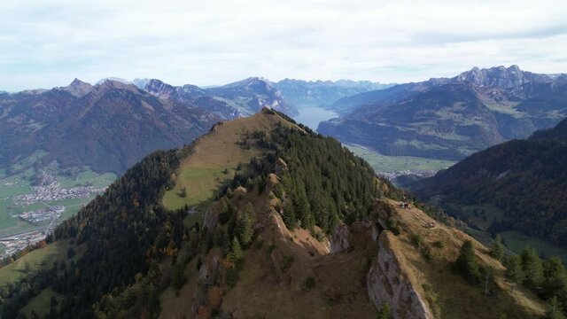 People on huge mountain ridge in the swiss alps, aerial circle pan