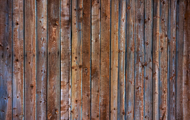A wooden wall with an aged surface.
Vintage wall and floor made of darkened wood, realistic plank texture.
 Empty room interior background.