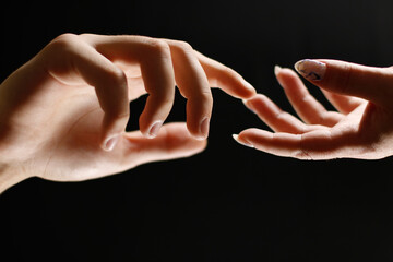 two hands reach out to each other