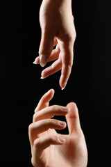 two hands reach out to each other