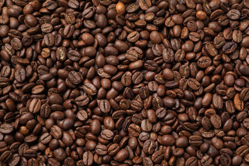 Pile of roasted coffee beans as background, top view