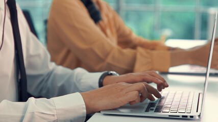Close up shot of business people hand typing and working actively . Call center, telemarketing, customer support agent provide service on telephone video conference call.