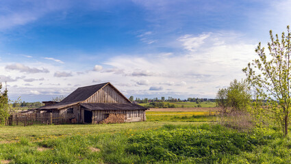 a village house in a field. Russian hut