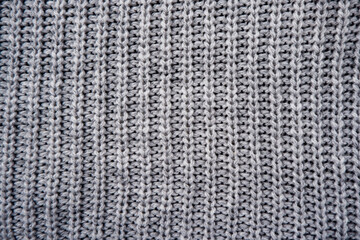 the texture of a gray knitted woolen jacket, sweater