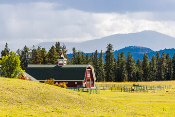 Red Barn With Mountains In The Distance, Lake County, Montana, USA