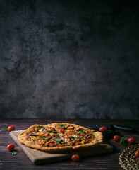 Fresh baked thin crust Italian pizza with tomato sauce pepper cheese and basil leaf on Dark rustic table background. - 467194710