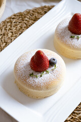 Delicious Japanese fluffy souffle pancakes on white cafe table. - 467194742