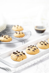 Delicious Whole Wheat Chocolate Chip Cookies set on white cafe table.