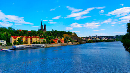 Vysehrad castle with river Vltava seen from the other side of the river in Summer day.