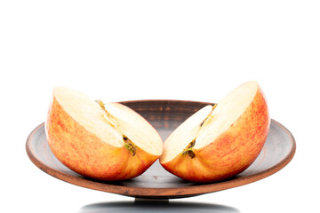 Two half organic juicy apples on a clay dish, close-up, isolated on white.