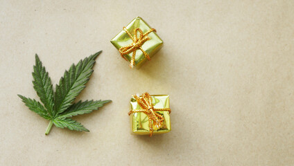 Cannabis leaf with gift boxes. Christmas presents. CBD marijuana products 