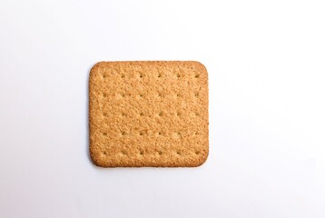 a single biscuit on white background, top view. selective focus