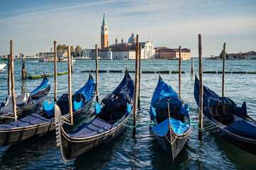 Gondolas in Venice on a sunny day in autumn - obrazy, fototapety, plakaty