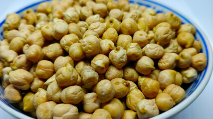 Detail view on chickpea in the Chinese porcelain bowl on the white background.