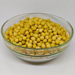 Detail view on soybean in the glass bowl on the white background.