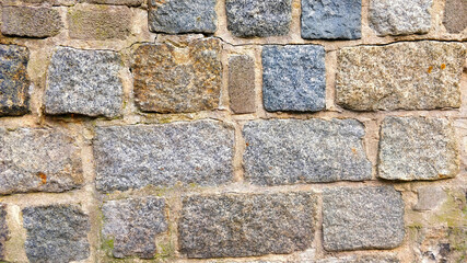 Detail view of wall structure made of block of stones connected with mortar.