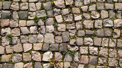 Detail view on old medieval road made of cobblestones.
