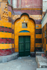 Fototapeta na wymiar colorful door entrance of an old chapel in cairo street, egypt