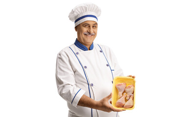 Mature male chef holding chicken drumsticks