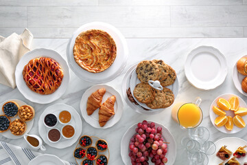 Variety of snacks on white marble table in buffet style indoors, flat lay