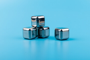 stainless steel ice cubes whiskey stones on blue background
