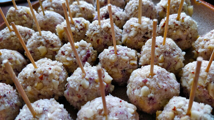 Detail of cheese balls on stick ready to be eaten on a party. It's part of canape dish.