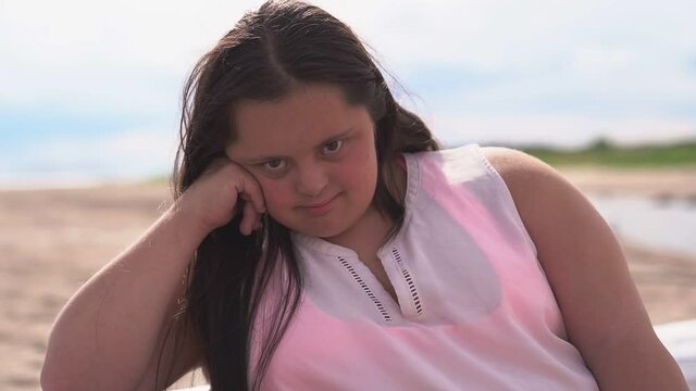 A trisomy 21 woman having fun at the beach