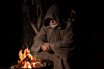 Medieval poor warrior around the campfire