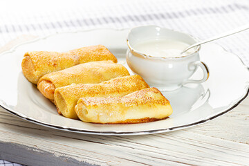 Pancakes stuffed with cottage cheese and sour cream