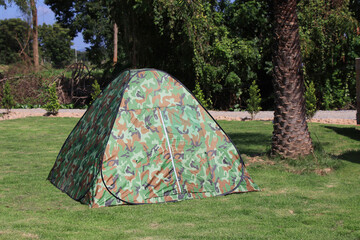 camouflage tent is located on the lawn