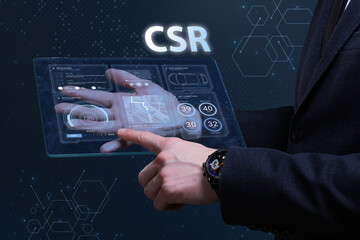 Business, Technology, Internet and network concept. Financial Graph. Stock Market chart. Young businessman working on a virtual screen of the future and sees the inscription: CSR