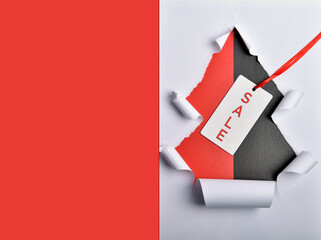 A hole in the shape of a Christmas tree with a label