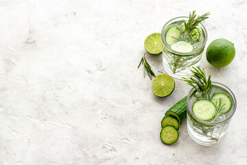 Cold fresh cocktail with lemon slices cucumber and rosemary