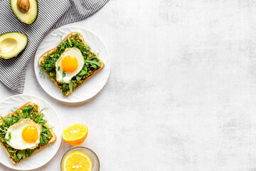Toasts with avocado and fried eggs. Healthy breakfast