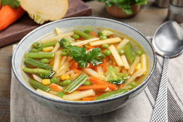 Bowl of delicious turnip soup on wooden table, closeup