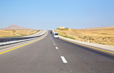 Fototapeta na wymiar endless scenic road across somewhere in Azerbaijan . Empty asphalt road across vast hilly landscape of Azerbaijan .