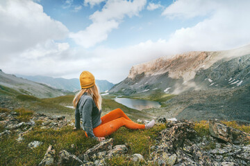 Hiker woman looking at lake and mountains view travel hiking alone outdoor active vacations...