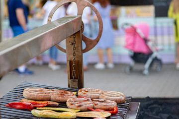 Sausage and vegetables are grilled over an open fire. Street food. BBQ picnic