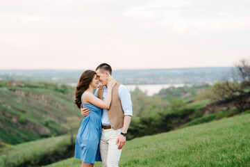 young couple a guy and a girl are walking in the mountain hills