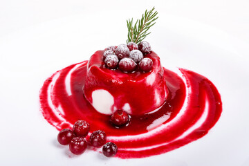 Milk dessert panna-cotta with cranberry sauce on white background