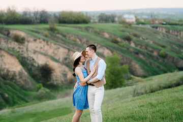 young couple a guy and a girl are walking in the mountain hills