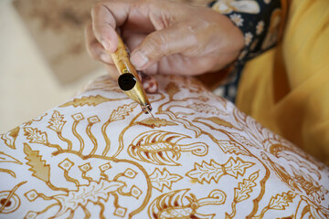 The process of making batik. Batik is a handmade traditional art from Indonesia. Produced by technique of wax-resist dyeing applied to fabric. - obrazy, fototapety, plakaty