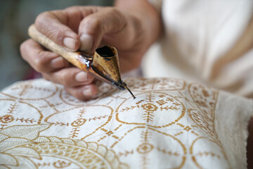 The process of making batik. Batik is a handmade traditional art from Indonesia. Produced by technique of wax-resist dyeing applied to fabric.