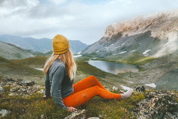 Traveler woman relaxing in mountains alone hiking outdoor active lifestyle vacations adventure mental health concept