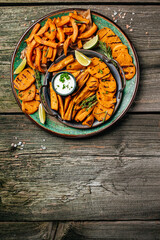 baked sweet potato with lime and sause. vertical image. top view. place for text