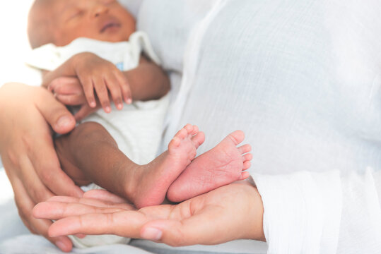 Baby's foot of African black skin newborn, Placed on the mother's hand, concept to showing love and concern for her children, And is love family relationship.