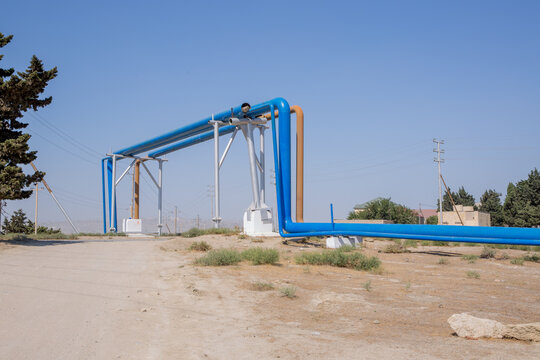 They have laid the groundwork for passing through the oil pipeline .industrial pipelines on pipe-bridge . Blue oil turbines.